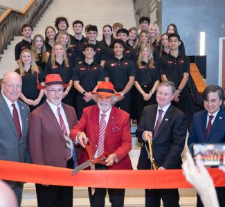 Dignitaries cut the ribbon on the new building.