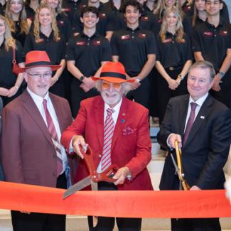 Dignitaries cut the ribbon on the new building.