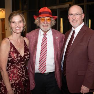 Herbert Wertheim, center, with Dean Michael Hartline and Hartline's wife, Marsha